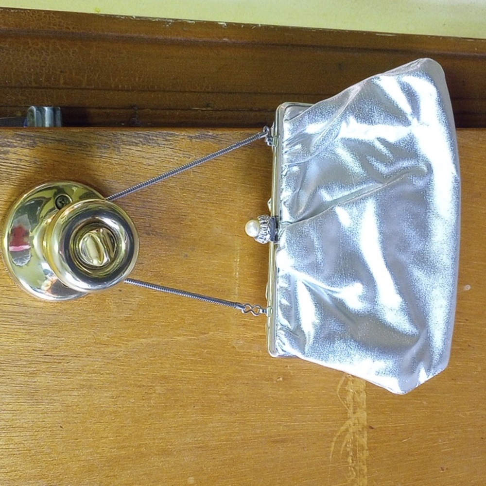 Silver clutch purse, cream interior, pearl closure, chain